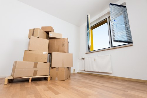 Handling items through a narrow Soho building entrance during relocation