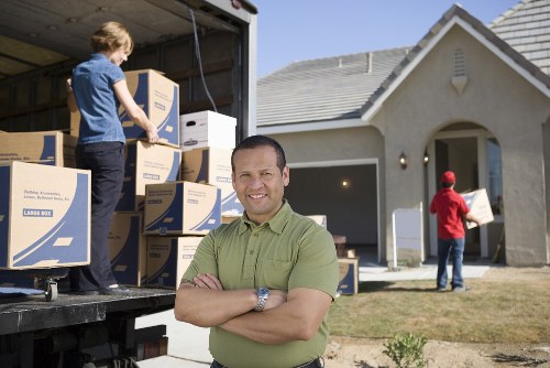 Professional movers handling furniture in a central London flat