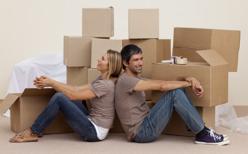 Workers lifting and carrying furniture safely during a move